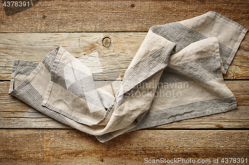 Image of linen napkin on wooden background