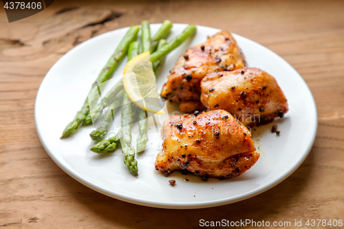 Image of Plate of grilled chicken meat and asparagus