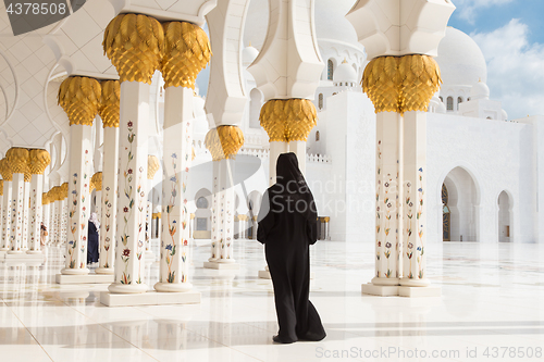 Image of Arabic woman in black burka in Sheikh Zayed Grand Mosque, Abu Dhabi, UAE.