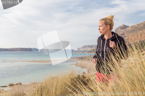 Image of Active Woman Jogging on Beach