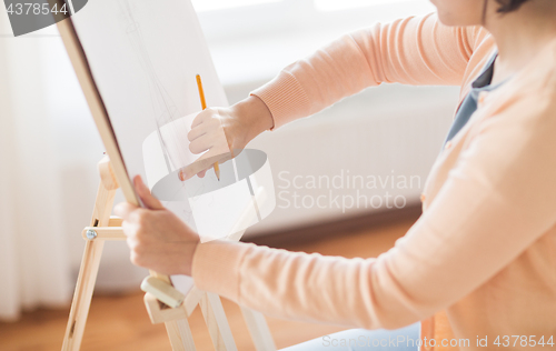 Image of artist with pencil drawing picture at art studio