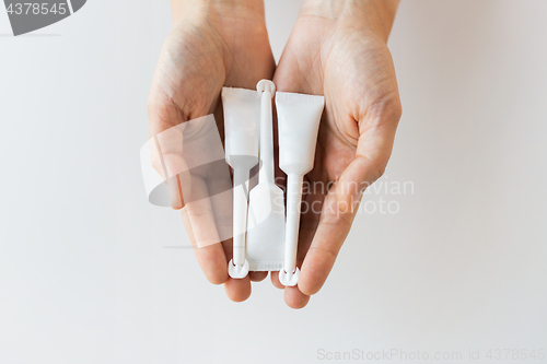 Image of hand holding tubes of micro enema