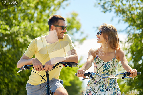 Image of happy couple with bicycles at country