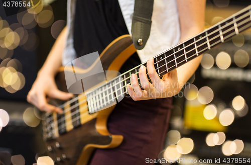 Image of close up of musician with guitar at music studio