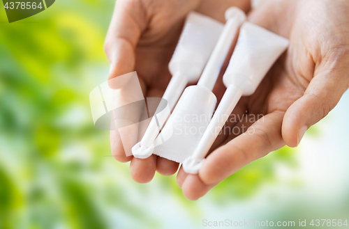 Image of hand holding tubes of micro enema