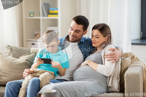 Image of happy family with smartphone at home