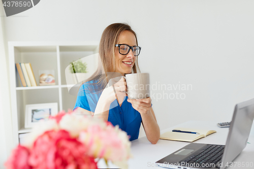 Image of woman with laptop and coffee at home or office