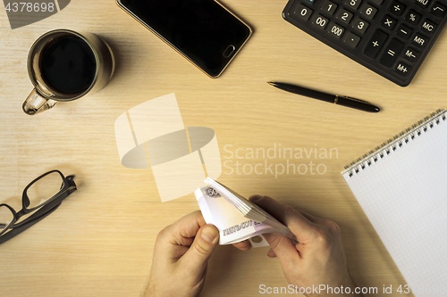 Image of Hands counting profit money in business space