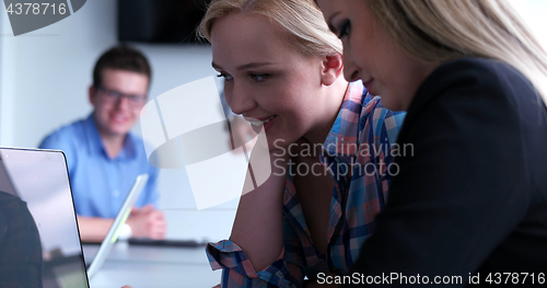 Image of group of business people having a meeting in bright office