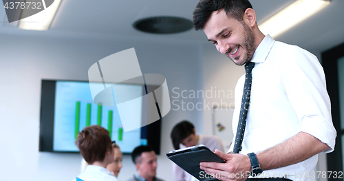 Image of Businessman using tablet in modern office