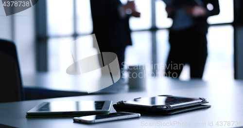 Image of tablet, mobile cell phone and cup of coffee  in office with busi