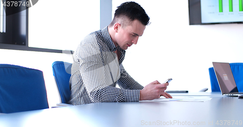 Image of Senior businessman  using cell phone at  stratup office