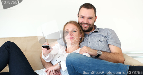 Image of senoior couple watching tv in modern villa