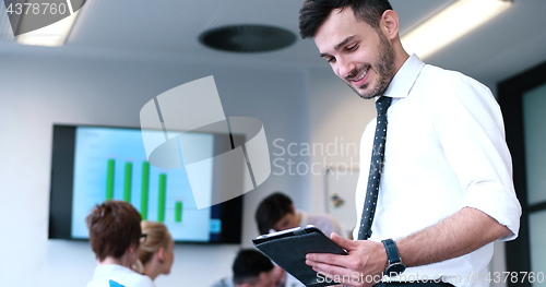 Image of Businessman using tablet in modern office