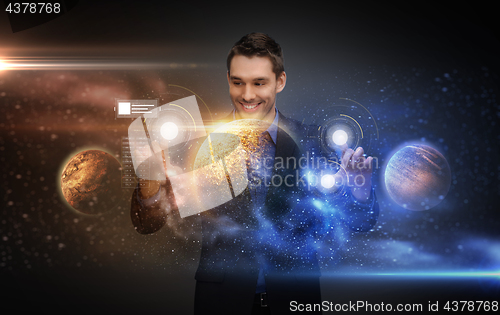 Image of businessman with virtual planets and space