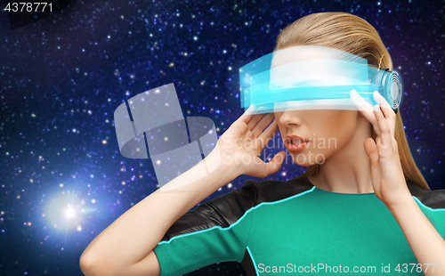 Image of woman in virtual reality glasses over space