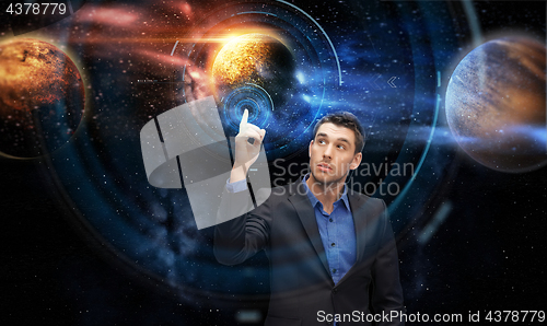 Image of businessman with virtual planets and space