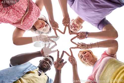 Image of group of happy friends showing peace hand sign 