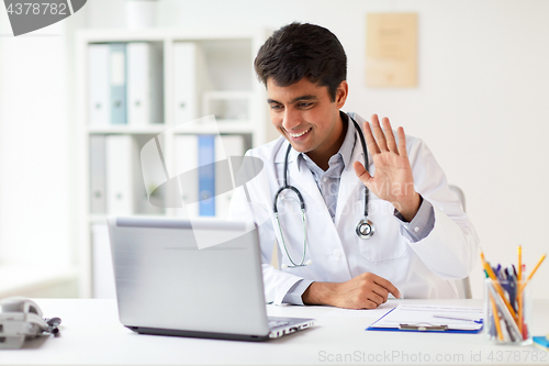 Image of doctor having video conference on laptop at clinic