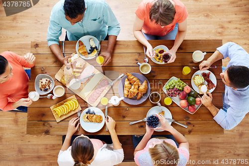 Image of group of people having breakfast at table