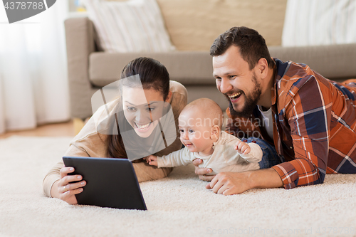 Image of mother, father and baby with tablet pc at home