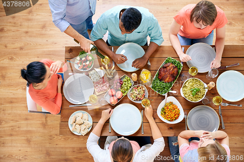 Image of group of people eating at table with food