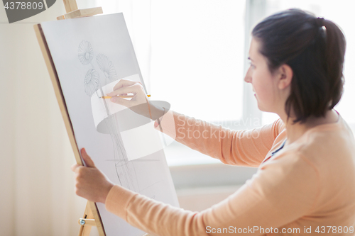 Image of artist with pencil drawing picture at art studio