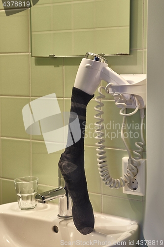 Image of Drying sock in a hairdryer