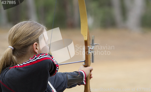 Image of teenage girl doing archery