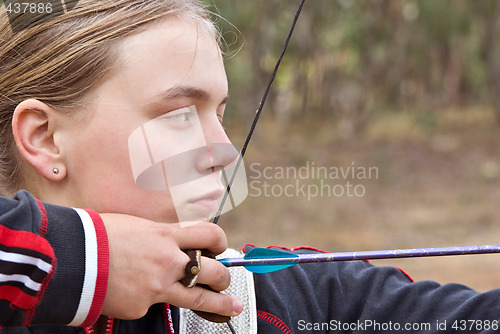 Image of teenage girl doing archery