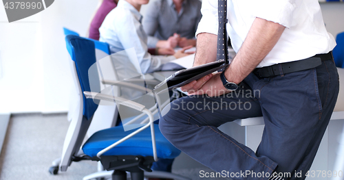 Image of Businessman using tablet in modern office