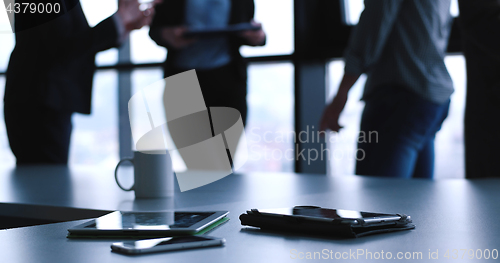 Image of tablet, mobile cell phone and cup of coffee  in office with busi