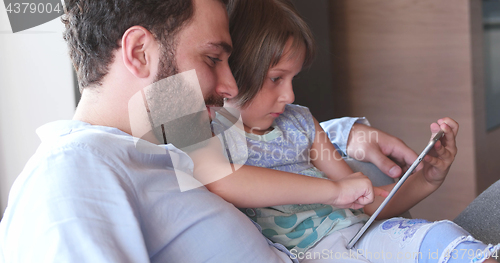 Image of Father Daughter using Tablet in modern apartment