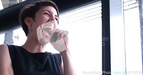 Image of Business Girl Standing In A Modern Building Near The Window With