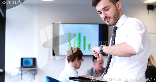 Image of Businessman using tablet in modern office