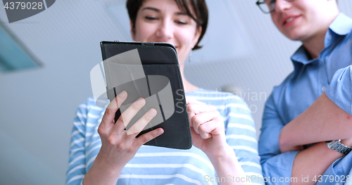 Image of low angle shot of business people using technology
