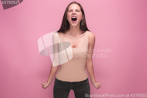 Image of Frustrated young woman screaming at studio