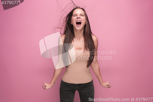 Image of Frustrated young woman screaming at studio