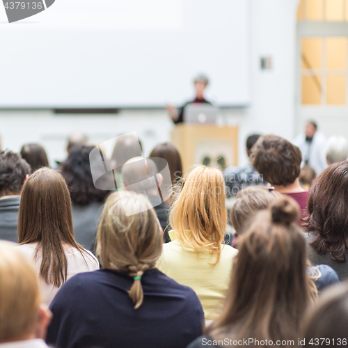 Image of Woman giving presentation in lecture hall at university.