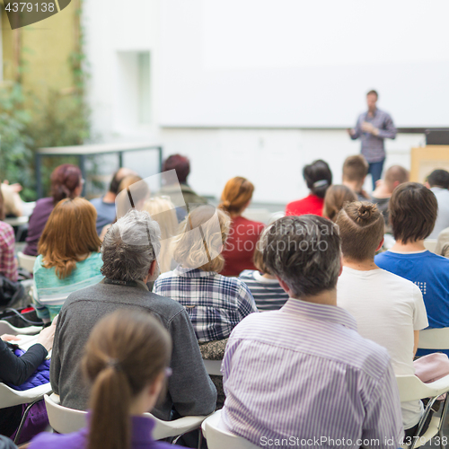 Image of Man giving presentation in lecture hall at university.