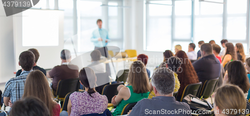 Image of Speaker giving presentation on business conference.