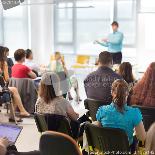 Image of Speaker giving presentation on business conference.