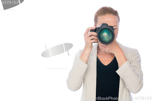 Image of Woman photographer takes images with dslr camera