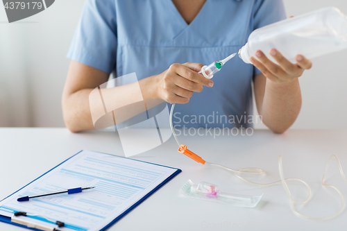 Image of close up of nurse preparing drop counter