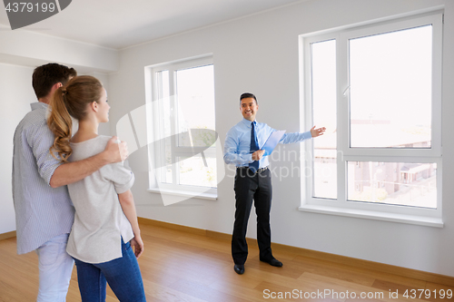 Image of realtor with clipboard and couple at new home