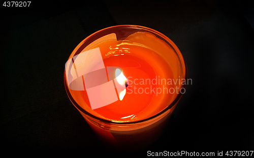 Image of Burning candle in the dark