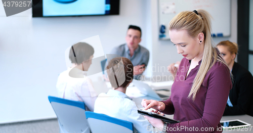 Image of Pretty Businesswoman Using Tablet In Office Building during conf