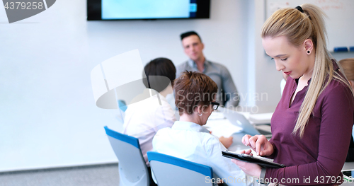 Image of Pretty Businesswoman Using Tablet In Office Building during conf