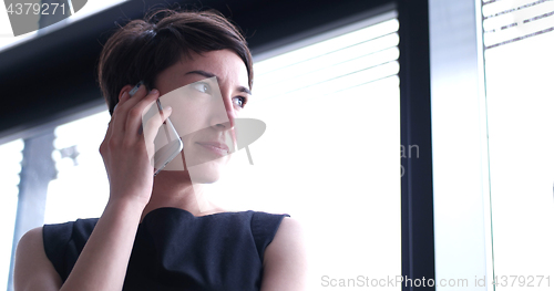 Image of Business Girl Standing In A Modern Building Near The Window With