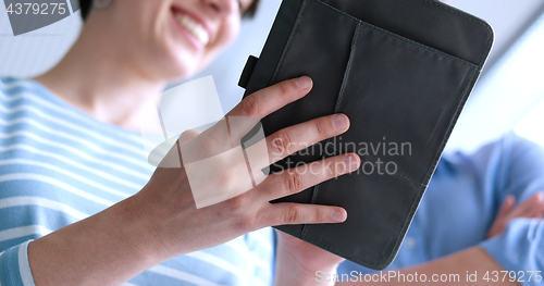 Image of low angle shot of business people using technology